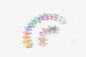 Macro shot of colorful pearlescent bow beads with iridescent finish for DIY jewelry