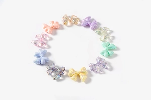 Detailed collection of aurora resin bow beads in diverse colors for DIY jewelry crafts