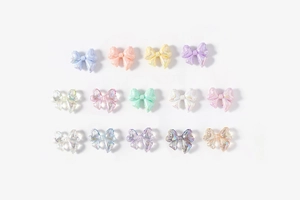 Macro detail of assorted pastel bow beads with aurora pearlescent finish for DIY crafts