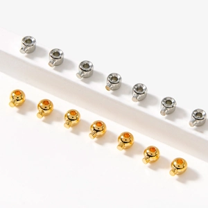 Polished 18K gold and silver cylinder cord ends for jewelry making on white stands