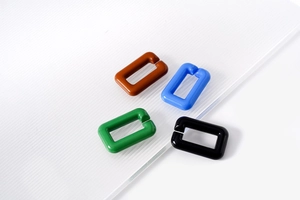 Detail of colorful acrylic rectangular open links for DIY jewelry and bag chain accessories