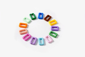 Detailed overhead view of various colorful acrylic U-shaped chain links for DIY accessories