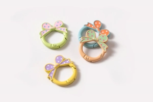 Detailweergave van vier kleurrijke legering veerringen met polka dot strikversiering