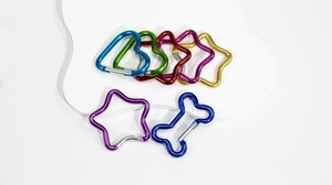 Close-up of assorted colorful star and heart shaped alloy spring keyrings and snap hooks