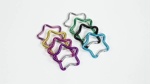 Close-up of star-shaped carabiner clips in eight vibrant colors for DIY keychain crafts