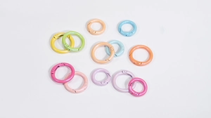 Close-up of assorted macaron-colored metal spring O-rings in various sizes for DIY crafts