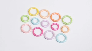 Macro view of colorful pearlescent O-rings in various sizes and spring clasp metal finishes