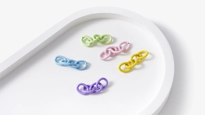 Close-up of matte alloy connecting rings in pastel colors for DIY jewelry and crafts