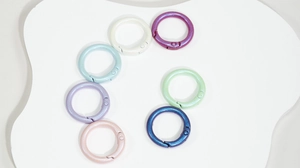 Close-up of pearl-finish colorful metal spring rings for DIY keychains and bags