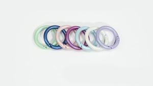 Close-up of colorful pearlescent spring O-rings in mint, rose gold, and lavender purple