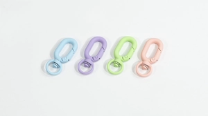 Close-up of colorful matte spring gate rings and swivel lobster hooks for DIY keychains