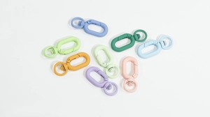 Macro view of macaron colored oval spring gate rings with 360-degree swivel base