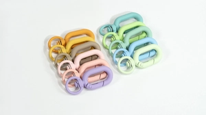 Macro shot of colorful matte macaron spring ring hooks with rotating connectors for DIY