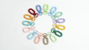 Macro shot of colorful matte spring lobster clasps arranged in a vibrant circular pattern