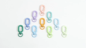 Macro detail of matte macaron color plastic swivel lobster clasps for DIY keychains