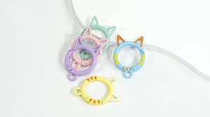 Close-up of five colorful cat-ear shaped spring rings for DIY keychain accessories