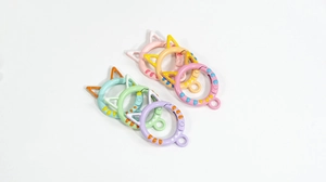 Detailed view of cat-shaped spring ring clasps in pastel colors with polka dot finish