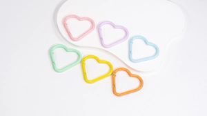 Close-up of heart-shaped macaron carabiners in six colors for DIY keychain accessories