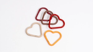 Detailed view of heart-shaped spring snap hooks in five different painted metal colors