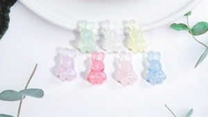 Macro shot of colorful acrylic bunny beads in pastel colors for DIY jewelry crafts