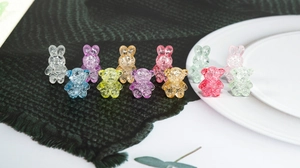 Close-up of colorful bear and rabbit beads with cracked ice texture for DIY jewelry