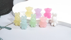 Close-up of colorful acrylic bear and rabbit beads in macaron tones for DIY jewelry making