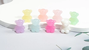 Macro detail of eight colorful macaron acrylic bear beads for DIY jewelry making