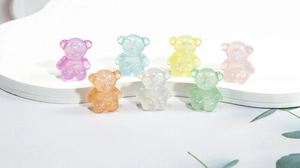 Macro shot of colorful acrylic bear charms with glitter effect for DIY jewelry making