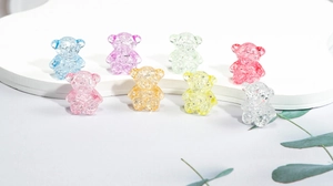 Detailed macro view of colorful acrylic bear beads with unique cracked ice texture effects