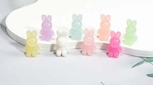 Close-up of colorful translucent acrylic bunny beads on a white stepped display stand