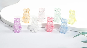 Macro shot of colorful acrylic bunny beads with cracked texture for DIY jewelry making