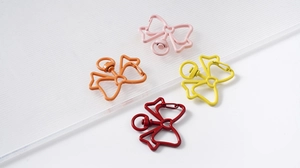 Detailed macro view of butterfly shaped metal lobster clasps in four bright colors
