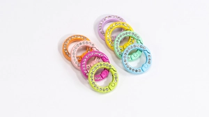 Close-up of colorful spring clasp rings with embedded rhinestones in candy colors