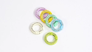 Close-up of rhinestone encrusted macaron color spring rings for DIY jewelry and keychains