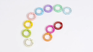 Close-up of colorful rhinestone spring ring buckles in vibrant candy macaron colors