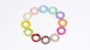 Macro shot of 12 colorful rhinestone round spring rings for DIY jewelry and keychains