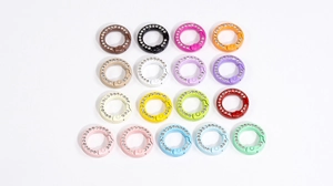 Macro shot of colorful rhinestone-studded spring ring clasps in seventeen vibrant candy colors