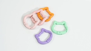 Macro shot of colorful cat-shaped spring ring buckles in assorted macaron colors