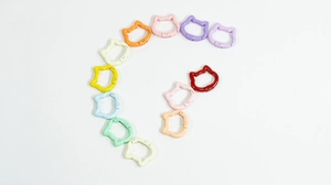 Detailed view of cat-shaped spring ring connectors in 12 assorted colorful finishes