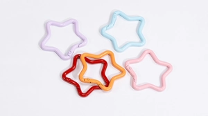 Close-up of five colorful star-shaped zinc alloy spring carabiners for keychains