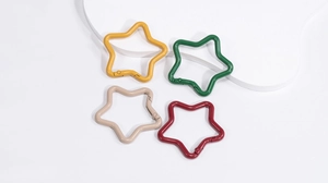 Macro detail of star-shaped spring snap hooks in matte colorful zinc alloy