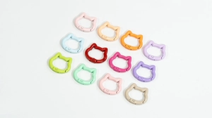Detailed macro shot of cat-shaped spring ring buckles in twelve diverse colorful finishes