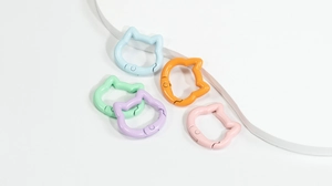Close-up of colorful cat-shaped spring ring buckles in pastel painted alloy finish