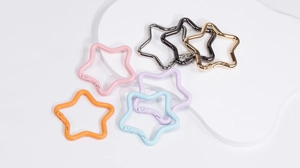 Macro view of colorful star-shaped spring snap hooks for backpacks and DIY accessories
