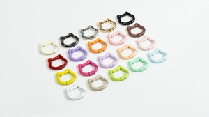 Close-up of cat-shaped spring snap hooks in twenty diverse colors for DIY keychains