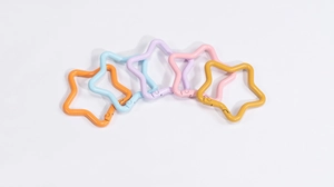 Close-up of star shaped spring snap hooks in five vibrant pastel colors for DIY crafts