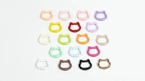 Detailed array of cat head shaped spring rings in 18 vibrant painted finish colors