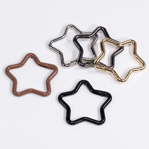 Star-shaped zinc alloy spring snap hooks in five metallic colors on white background