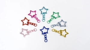 Vibrant star-shaped alloy keychains in 8 colors arranged in a circular radial layout