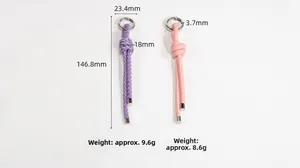 Detail of hand-woven purple and pink lanyard keychains with silver metal ring clasps